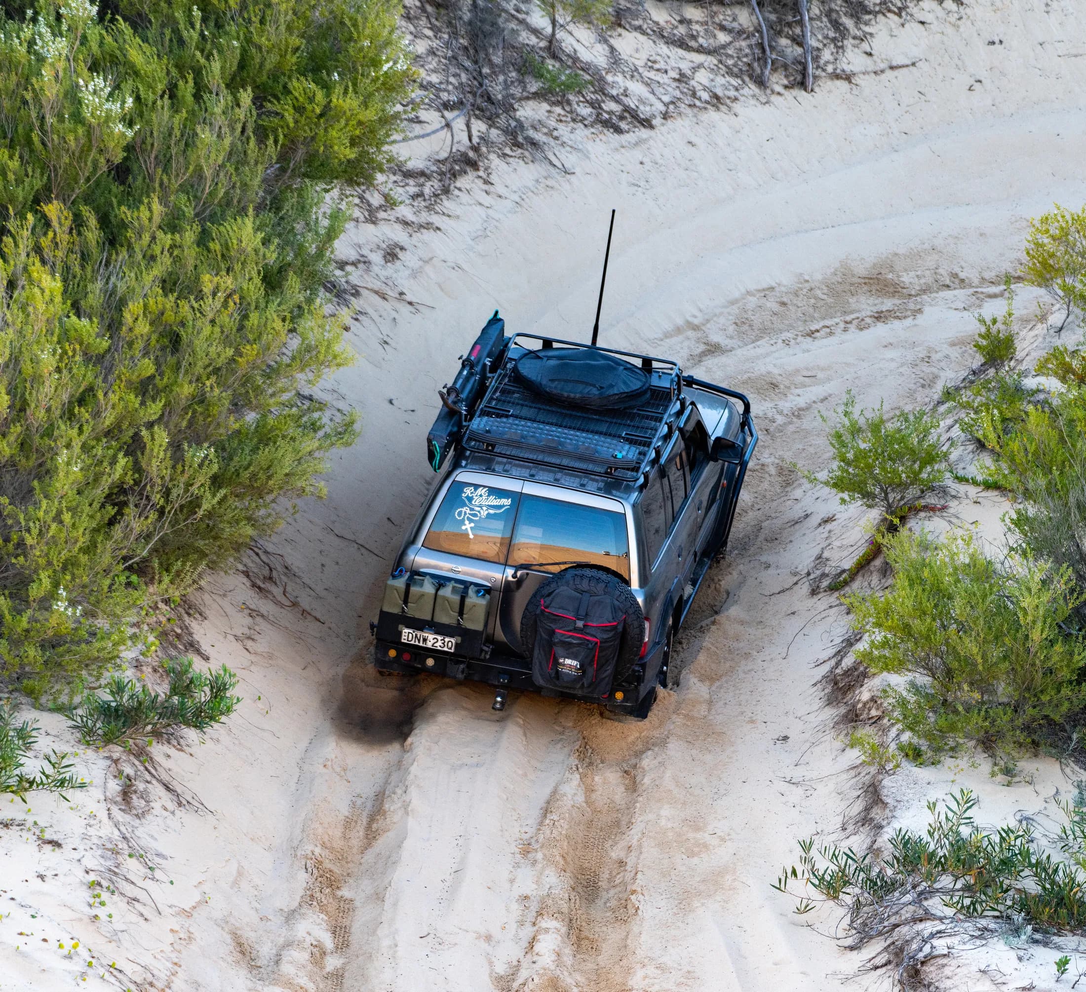 Four wheel drive raising dust on a sand track by Croome Photography
