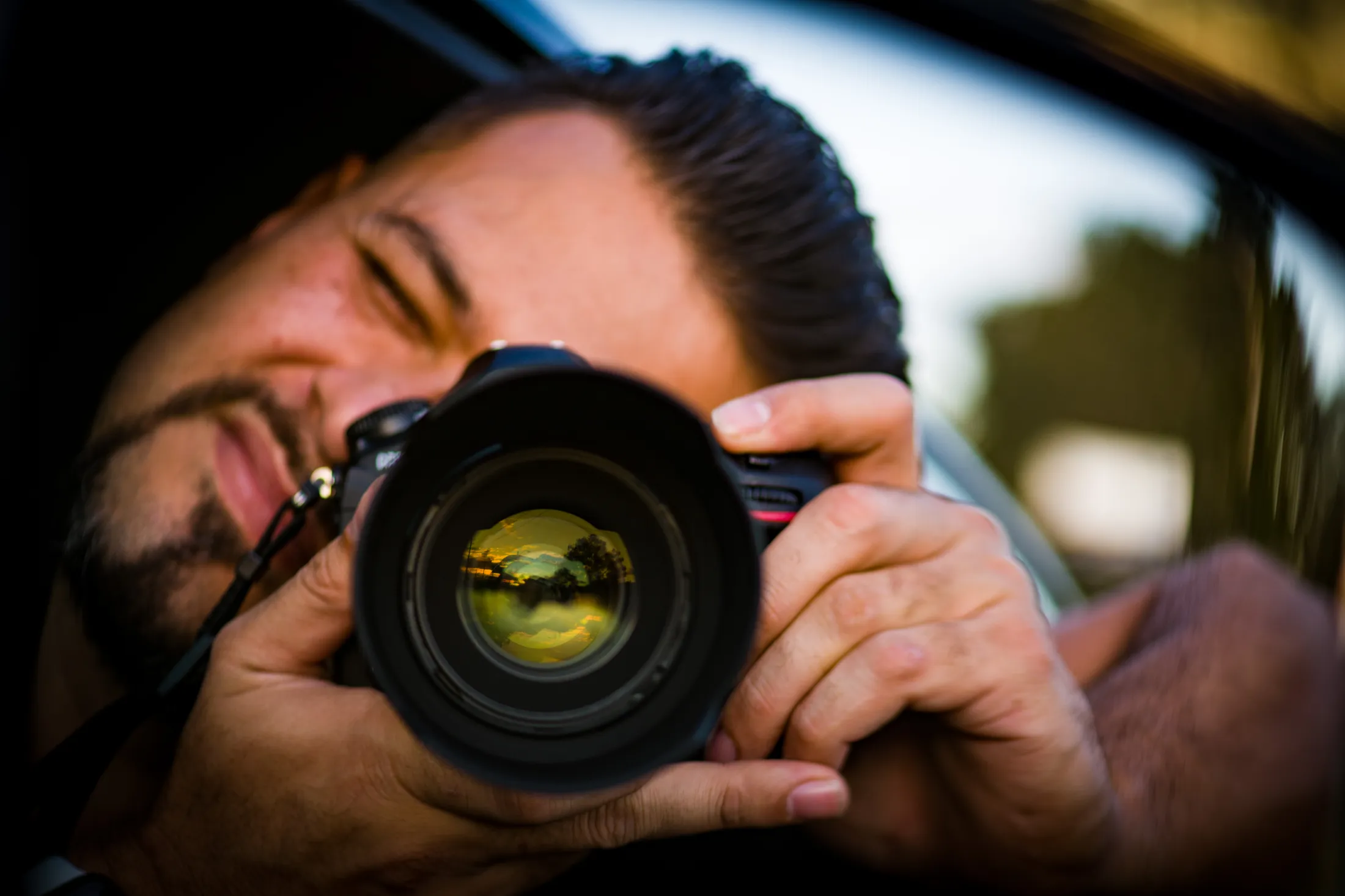 Portrait of a photographer holding a camera by Croome Photography